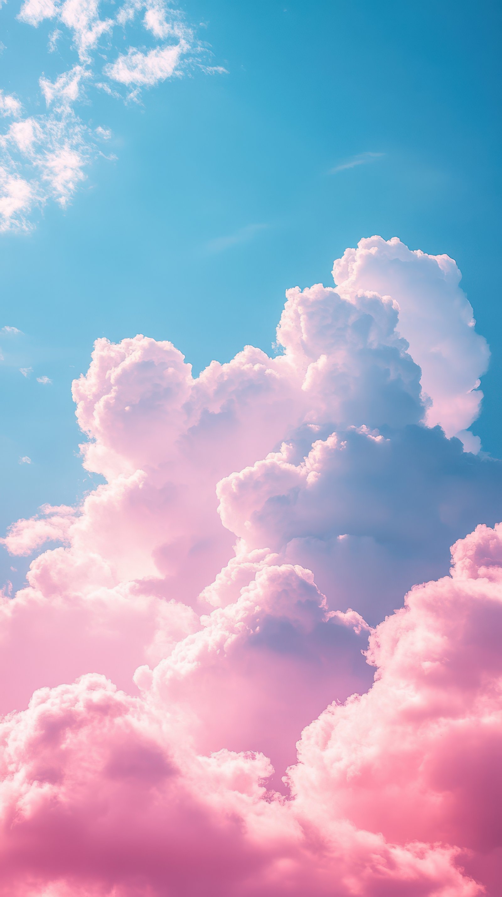 Beautiful pink and white clouds contrast against a bright blue sky during a serene afternoon